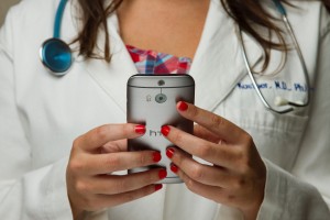 health care worker holding smartphone